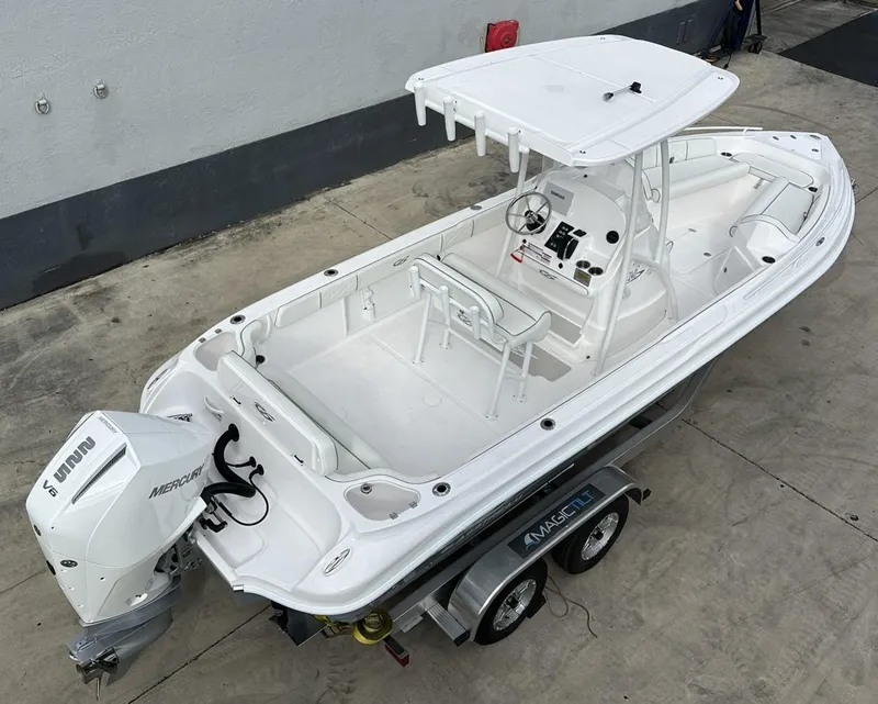 Slide: The Image of 2025 Glasstream 240 CCX boat on trailer, featuring a sleek white design and Mercury outboard motor. - 6