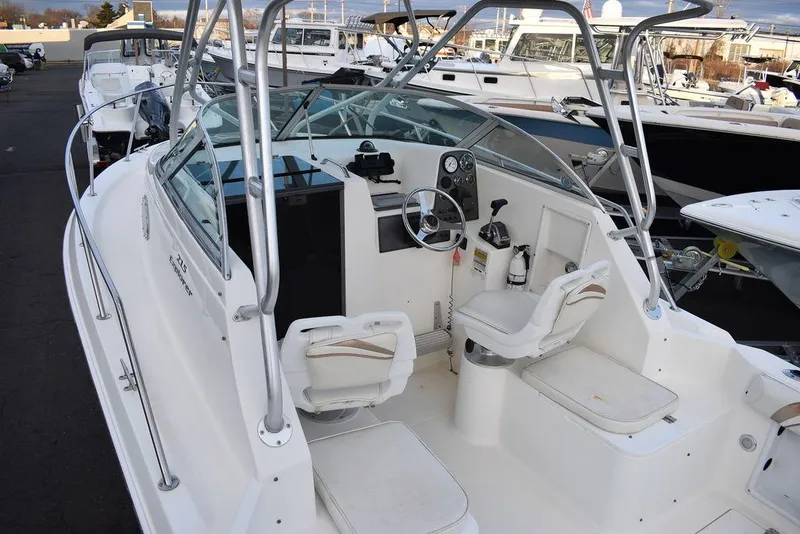 Slide: The Image of 2001 Aquasport 215 Explorer Walk-around boat with white interior and steering console. - 12