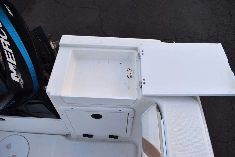 Slide: The Image of 2001 Aquasport 215 Explorer Walk-around boat with open storage compartment and Mercury engine. - 15