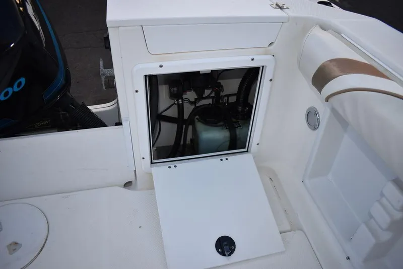 Slide: The Image of 2001 Aquasport 215 Explorer Walk-around boat interior compartment with open access panel. - 16