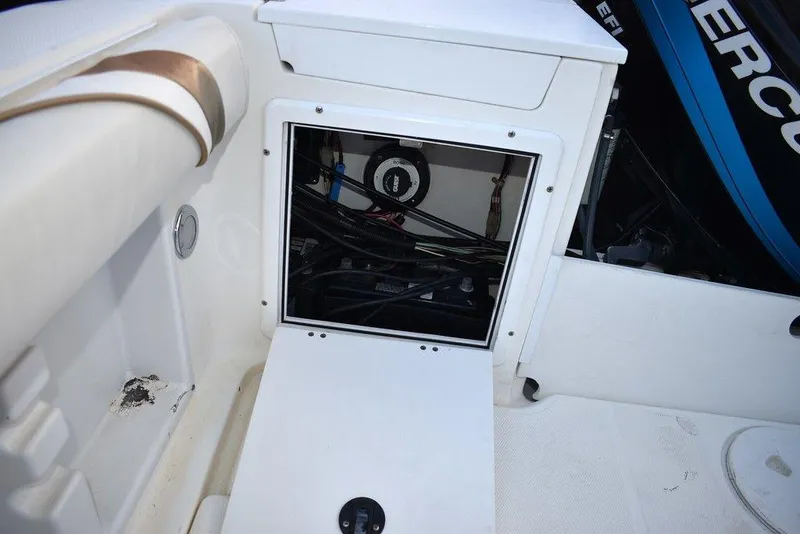 Slide: The Image of 2001 Aquasport 215 Explorer Walk-around boat interior compartment with wiring visible. - 19