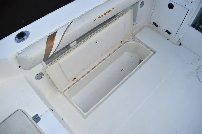 Slide: The Image of 2001 Aquasport 215 Explorer Walk-around boat storage compartment, open and empty. - 20