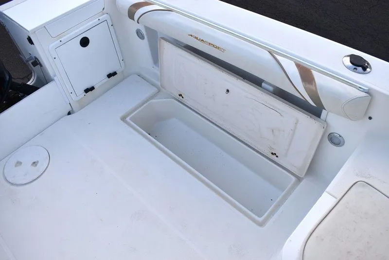 Slide: The Image of 2001 Aquasport 215 Explorer Walk-around boat interior with storage compartment open. - 21