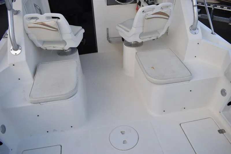 Slide: The Image of 2001 Aquasport 215 Explorer Walk-around boat interior with seating and helm. - 22