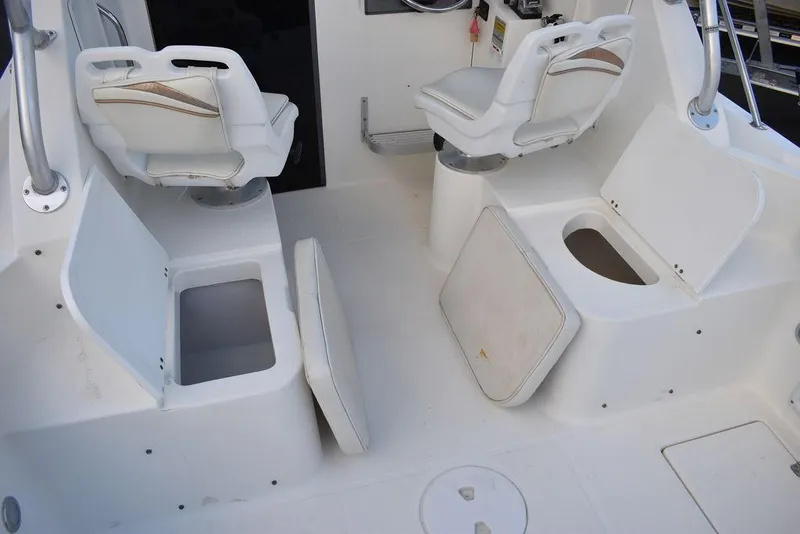 Slide: The Image of 2001 Aquasport 215 Explorer Walk-around boat interior with open storage compartments. - 23