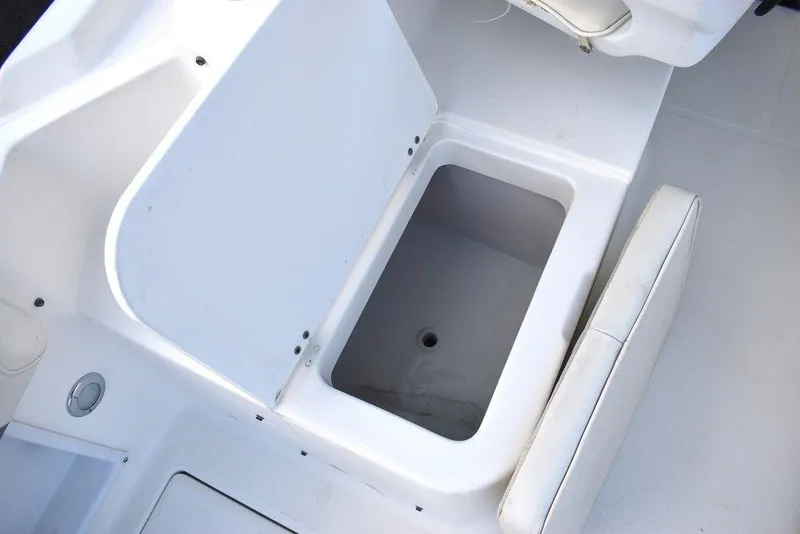 Slide: The Image of 2001 Aquasport 215 Explorer Walk-around boat storage compartment with open lid. - 24