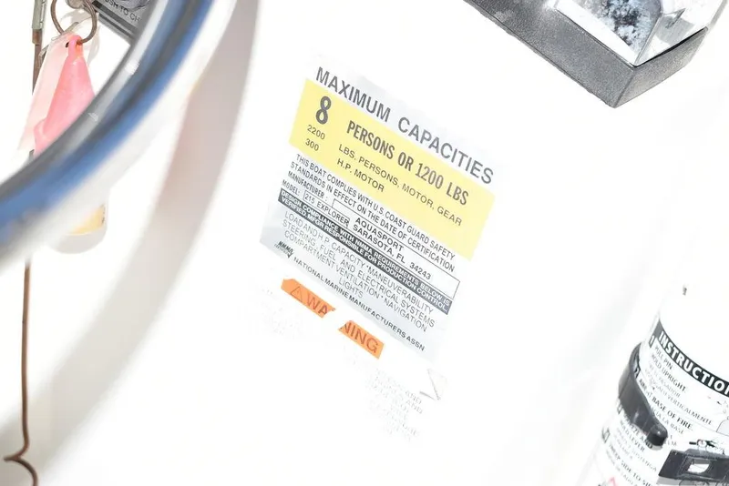 Slide: The Image of Capacity label on 2001 Aquasport 215 Explorer Walk-around, max 8 persons or 1200 lbs. - 33