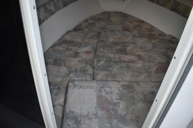 Slide: The Image of 2001 Aquasport 215 Explorer cabin interior with patterned cushions. - 38