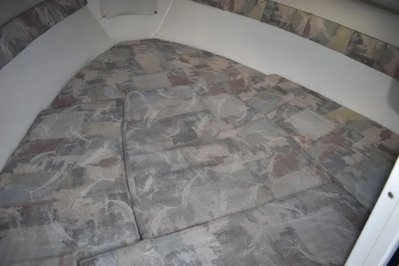 Slide: The Image of 2001 Aquasport 215 Explorer Walk-around cabin interior with patterned cushions. - 39
