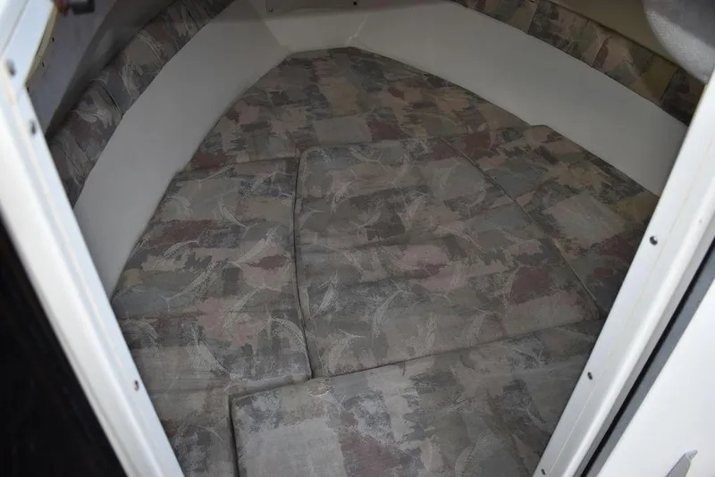 Slide: The Image of 2001 Aquasport 215 Explorer Walk-around cabin interior with patterned cushions. - 41