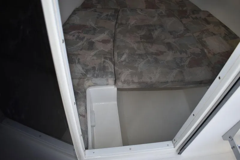 Slide: The Image of 2001 Aquasport 215 Explorer Walk-around cabin interior with cushioned seating. - 42