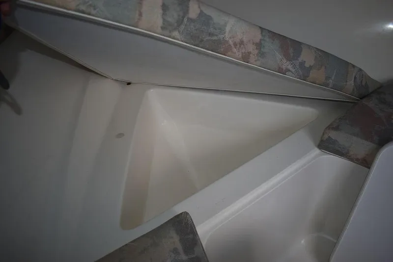 Slide: The Image of 2001 Aquasport 215 Explorer Walk-around interior storage compartment with cushioned seating. - 43