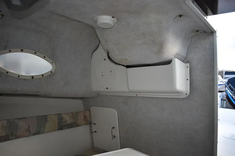 Slide: The Image of 2001 Aquasport 215 Explorer Walk-around cabin interior with seating and storage. - 44