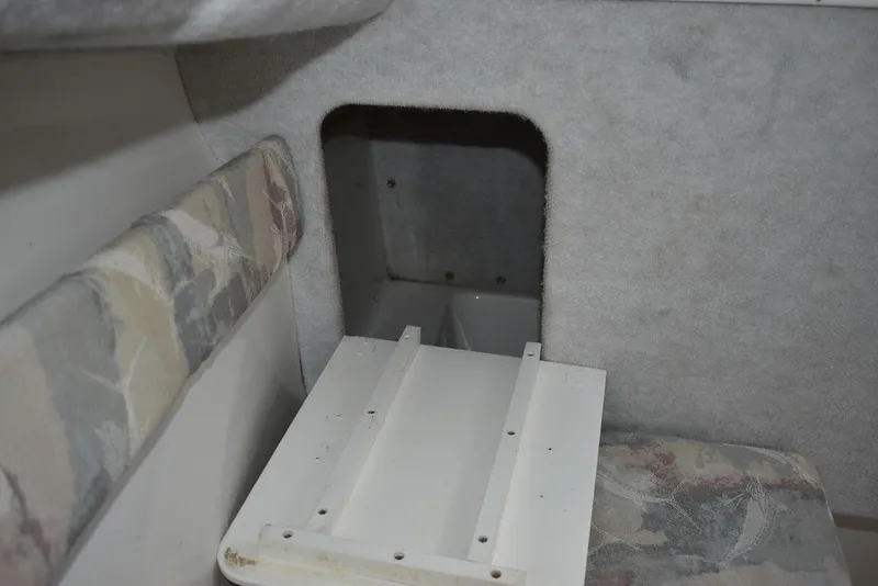 Slide: The Image of Interior of 2001 Aquasport 215 Explorer Walk-around boat, featuring seating and storage area. - 48