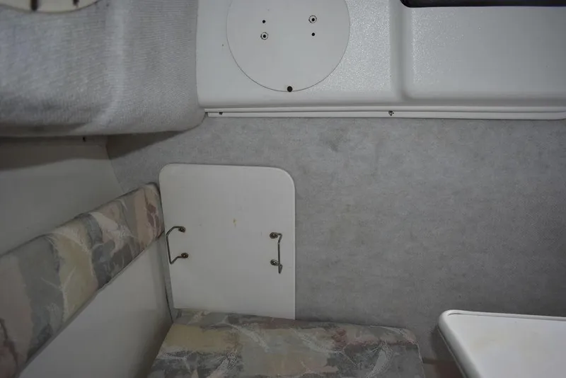 Slide: The Image of Interior cabin of 2001 Aquasport 215 Explorer Walk-around boat, featuring seating and storage. - 49