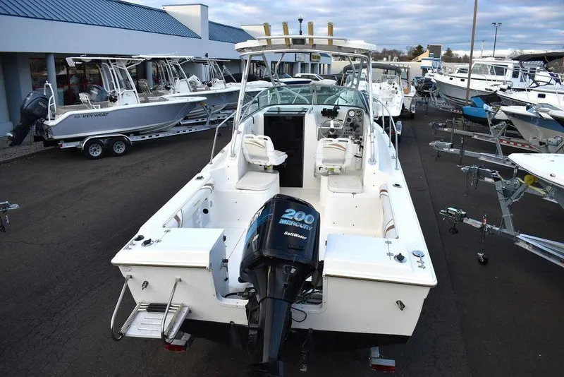 Slide: The Image of 2001 Aquasport 215 Explorer Walk-around boat with outboard motor, docked at marina. - 9