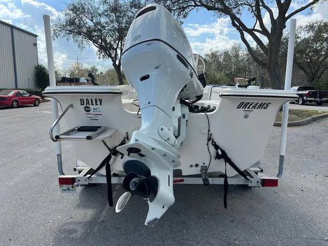 Slide: The Image of 2023 Carolina Skiff 19 LS boat with outboard motor, parked outdoors. - 2