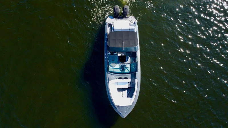 Slide: The Image of 2021 Cruisers Yachts 338 South Beach Edition Bow Rider on water, aerial view. - 10