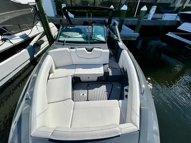 Slide: The Image of 2021 Cruisers Yachts 338 South Beach Edition Bow Rider, luxurious seating, docked in marina. - 13