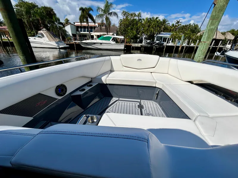 Slide: The Image of 2021 Cruisers Yachts 338 South Beach Edition Bow Rider, luxurious seating, docked by palm trees. - 15