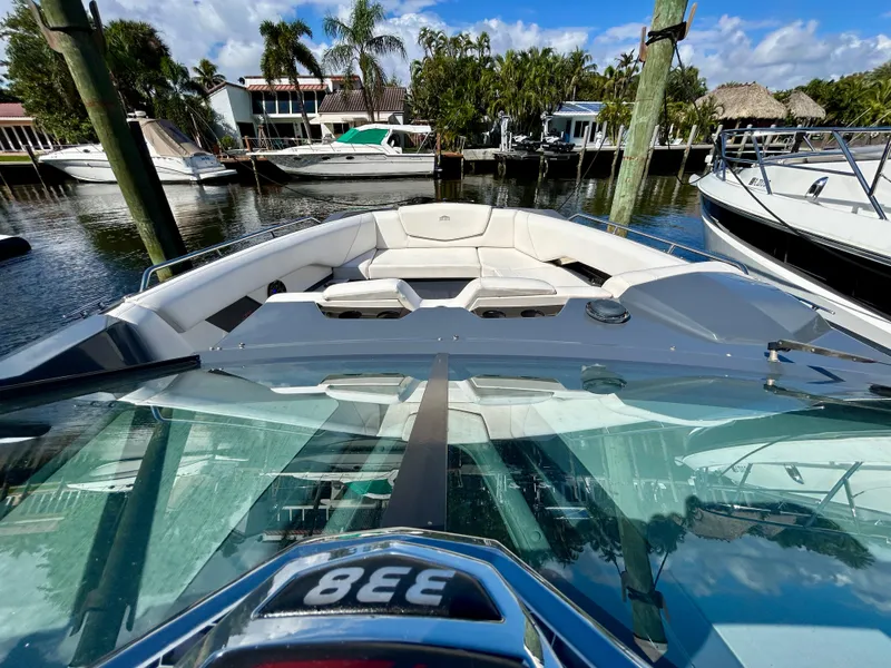 Slide: The Image of 2021 Cruisers Yachts 338 South Beach Edition Bow Rider at marina, sunny day. - 16