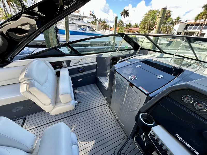 Slide: The Image of 2021 Cruisers Yachts 338 South Beach Edition Bow Rider interior with sleek design and modern controls. - 18