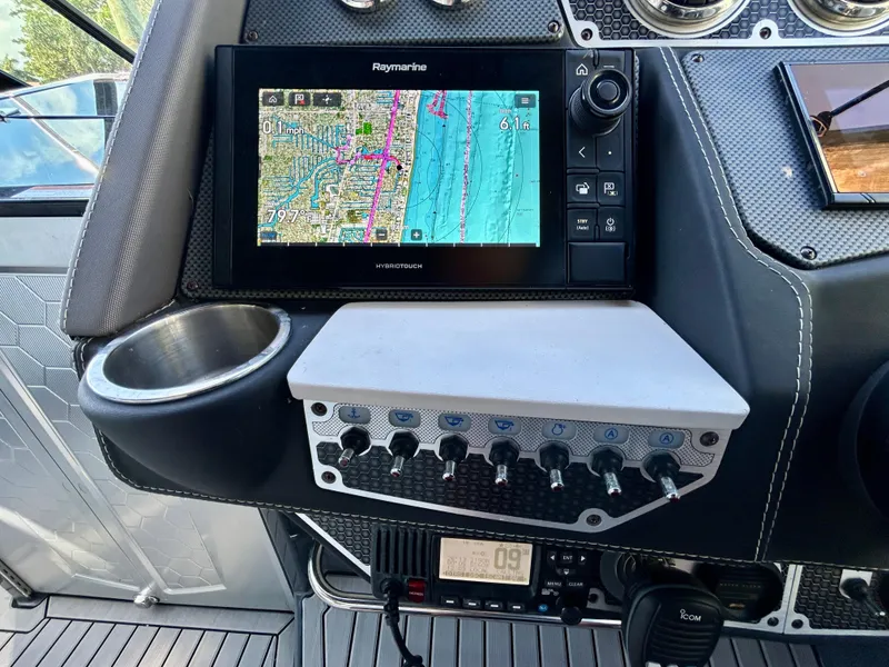 Slide: The Image of Control panel of 2021 Cruisers Yachts 338 South Beach Edition Bow Rider with navigation display. - 25