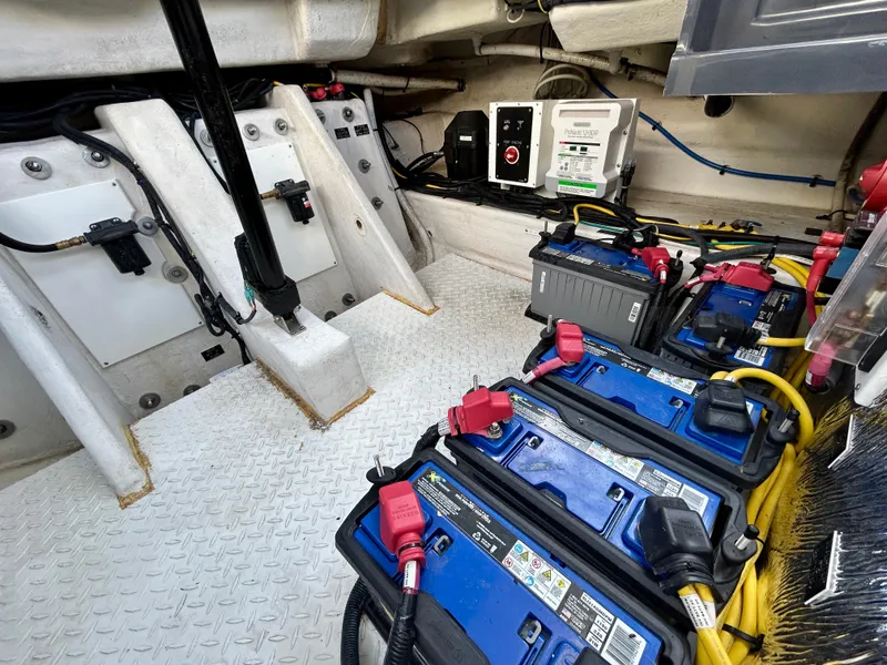Slide: The Image of Engine compartment of 2021 Cruisers Yachts 338 South Beach Edition Bow Rider with batteries and wiring. - 47