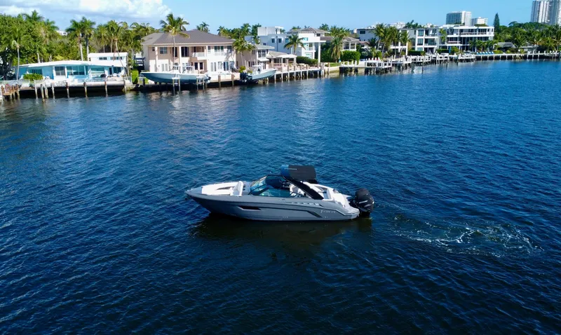 Slide: The Image of 2021 Cruisers Yachts 338 South Beach Edition Bow Rider on a scenic waterfront. - 8