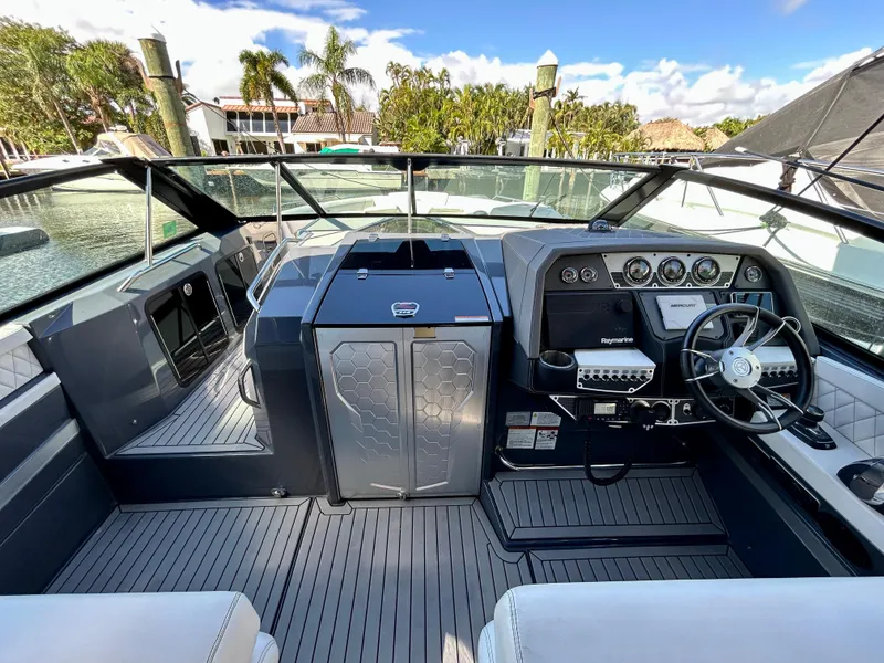 Slide: The Image of 2021 Cruisers Yachts 338 South Beach Edition Bow Rider interior with modern dashboard and steering. - 20
