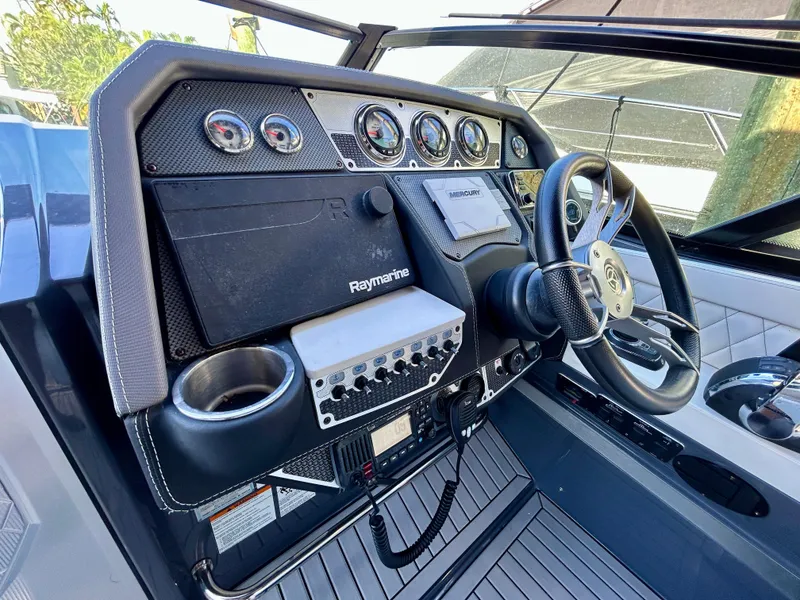 Slide: The Image of 2021 Cruisers Yachts 338 South Beach Edition Bow Rider dashboard with steering wheel and controls. - 22