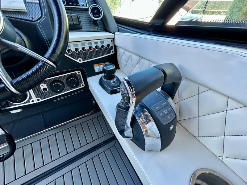 Slide: The Image of 2021 Cruisers Yachts 338 South Beach Edition Bow Rider cockpit with modern controls and luxurious design. - 24