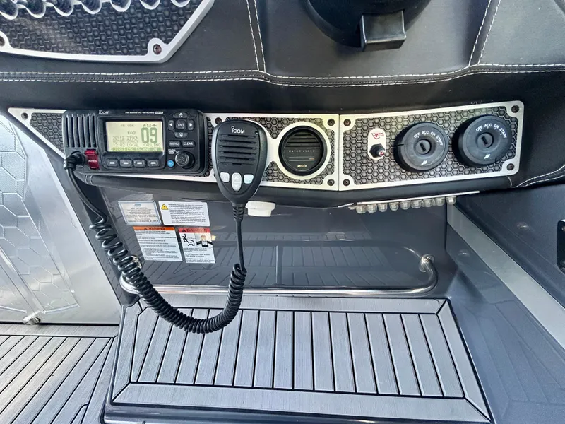 Slide: The Image of Control panel of 2021 Cruisers Yachts 338 South Beach Edition Bow Rider with radio and controls. - 27