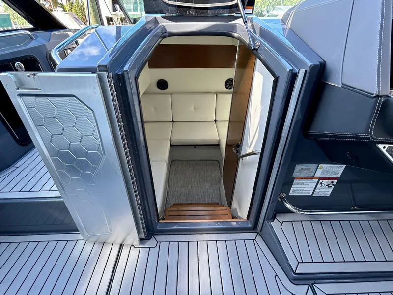 Slide: The Image of 2021 Cruisers Yachts 338 South Beach Edition Bow Rider cabin interior with seating and modern design. - 48