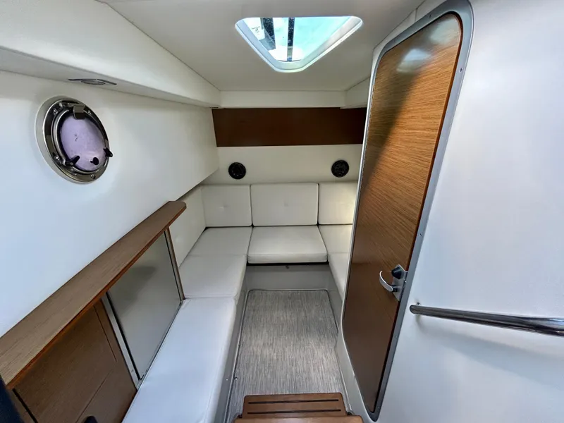 Slide: The Image of 2021 Cruisers Yachts 338 South Beach Edition Bow Rider cabin interior with seating and skylight. - 49