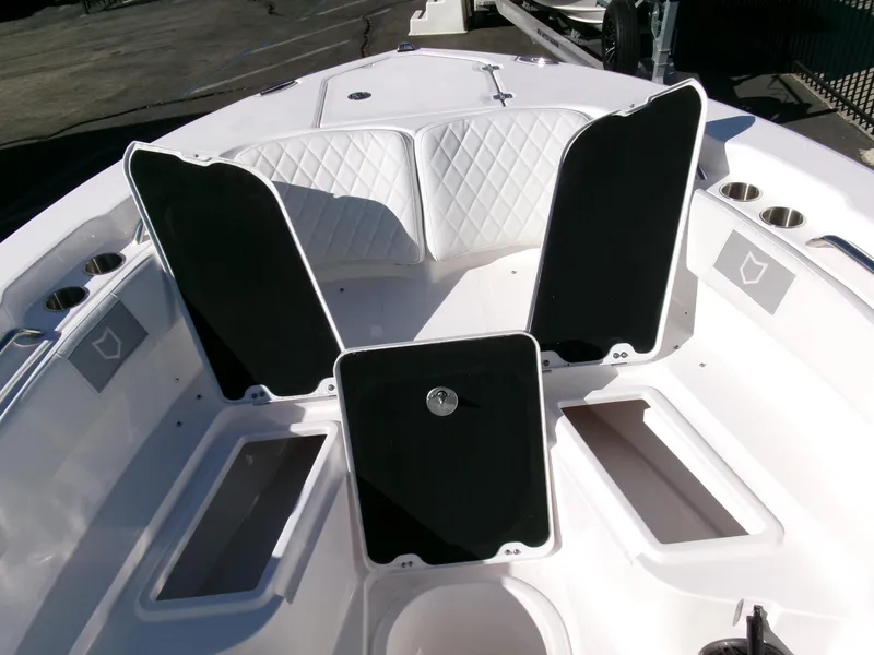 Slide: The Image of 2025 Sea Fox 228 Commander boat interior with open storage compartments and cushioned seating. - 11