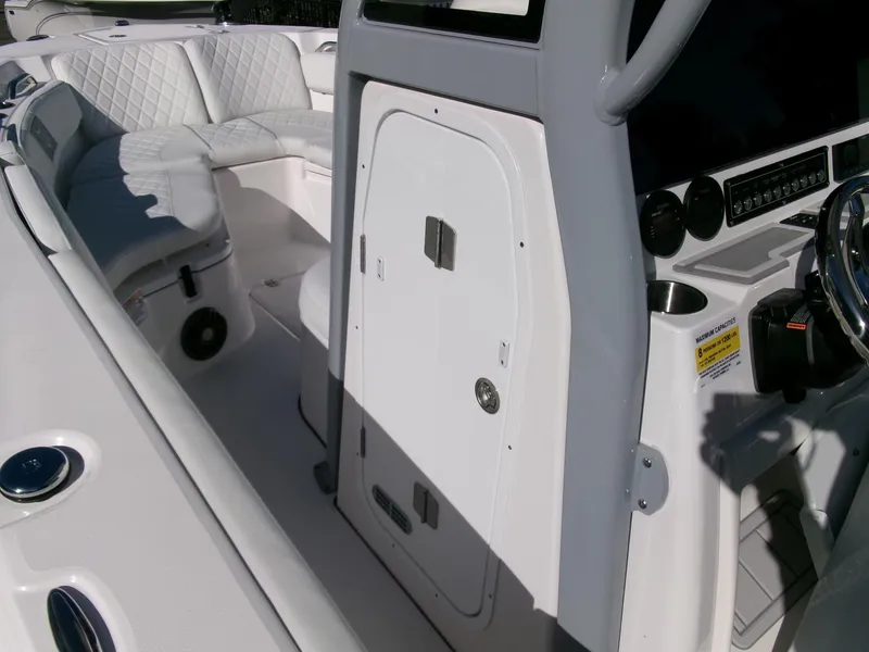 Slide: The Image of 2025 Sea Fox 228 Commander boat interior with white seating and control panel. - 15