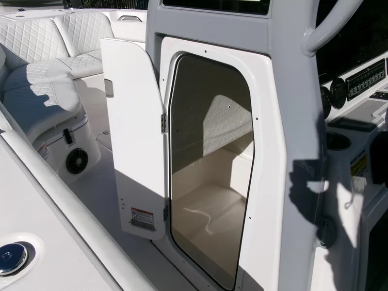 Slide: The Image of 2025 Sea Fox 228 Commander boat interior with open storage compartment and seating area. - 16