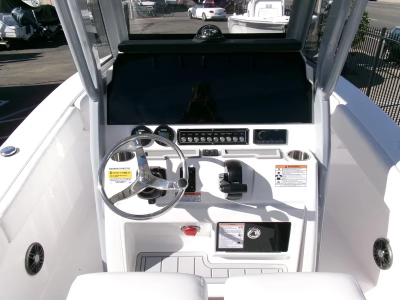 Slide: The Image of 2025 Sea Fox 228 Commander boat dashboard with steering wheel and control panel. - 18