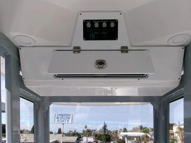 Slide: The Image of 2025 Sea Fox 228 Commander boat interior with control panel and storage compartment. - 19