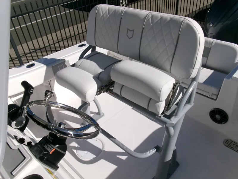 Slide: The Image of 2025 Sea Fox 228 Commander boat helm with cushioned seating and steering wheel. - 21