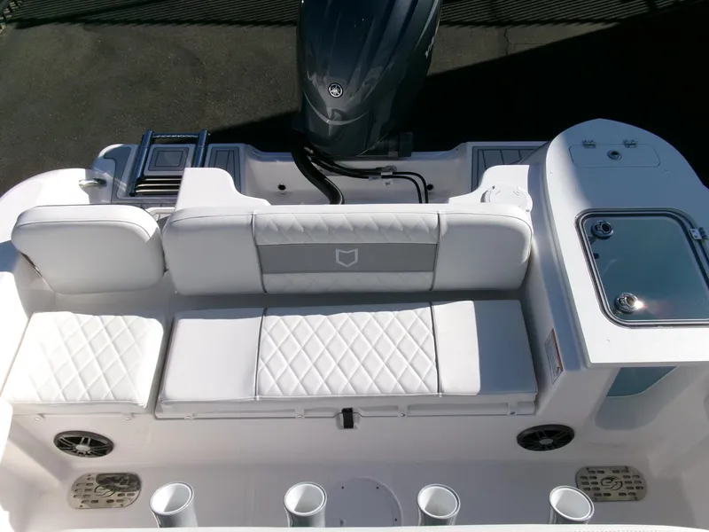 Slide: The Image of 2025 Sea Fox 228 Commander boat interior with cushioned seating and motor. - 25