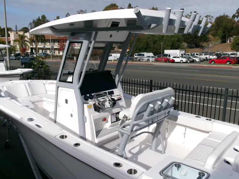 Slide: The Image of 2025 Sea Fox 228 Commander boat with modern console and seating, parked near a road. - 30
