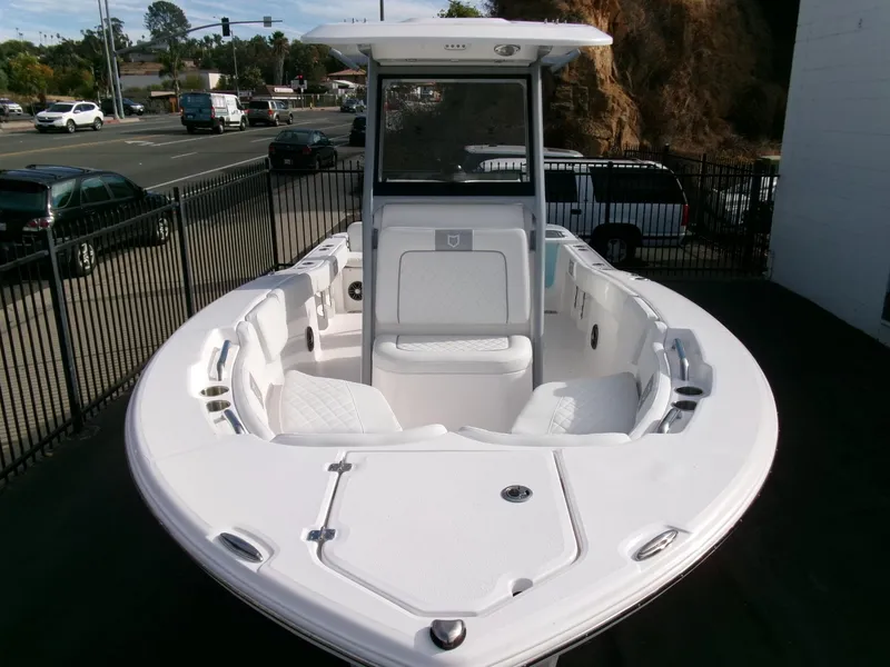 Slide: The Image of 2025 Sea Fox 228 Commander boat, white interior, parked near a road. - 37