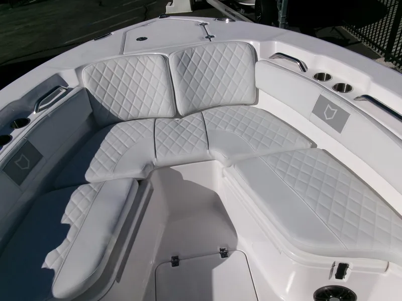 Slide: The Image of 2025 Sea Fox 228 Commander boat with white cushioned seating and cup holders. - 6