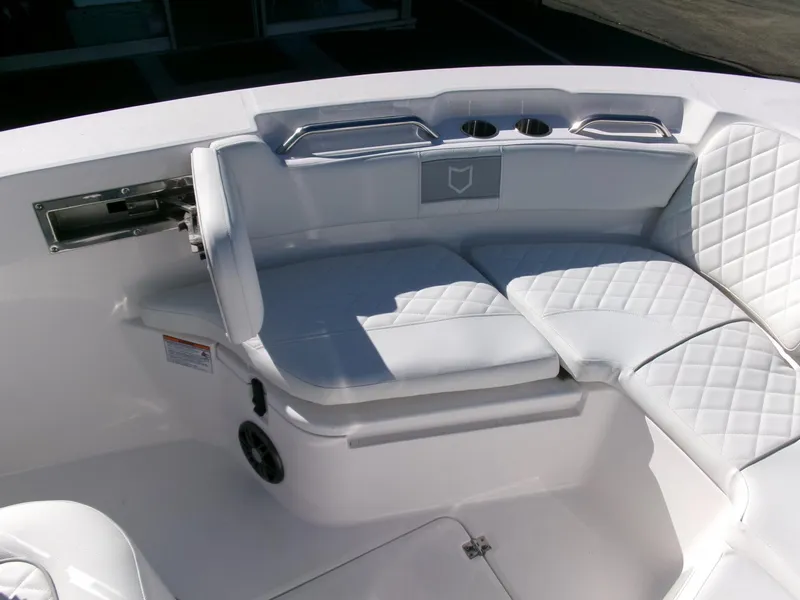 Slide: The Image of 2025 Sea Fox 228 Commander boat interior with white cushioned seating and stainless steel accents. - 9