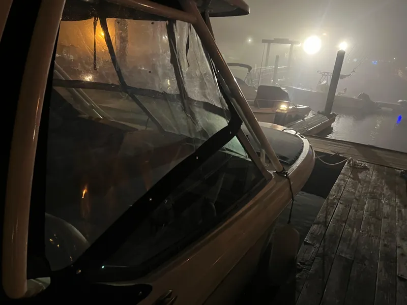 Slide: The Image of 2023 Boston Whaler 240 Vantage boat docked at night with misty lighting. - 8