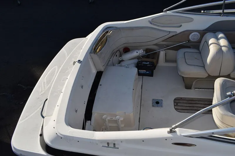 Slide: The Image of 1999 Maxum 2300SC boat interior with seating and storage compartments. - 11