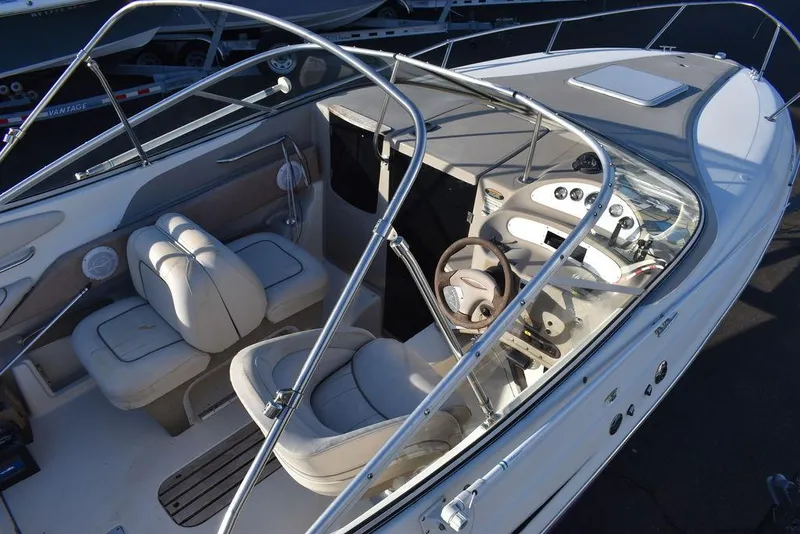 Slide: The Image of 1999 Maxum 2300SC boat interior with steering wheel, seating, and dashboard controls. - 12