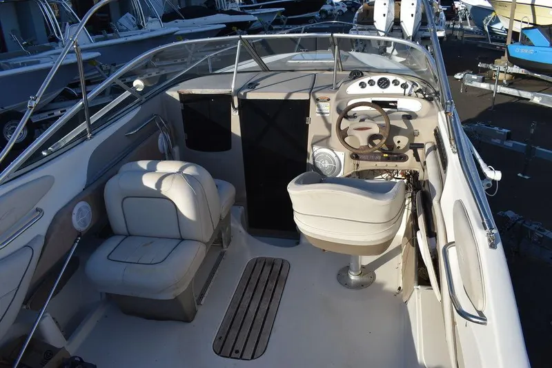 Slide: The Image of 1999 Maxum 2300SC boat interior with steering wheel, seating, and dashboard controls. - 14